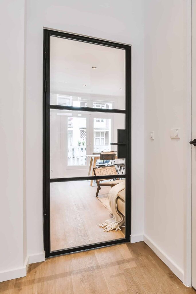 steel look interior doors in a slimline style between a hallway and lounge