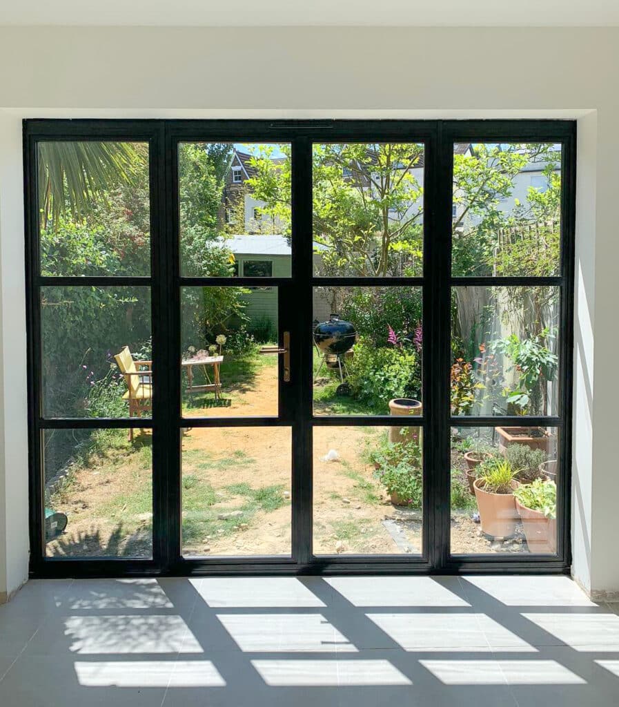 heritage style patio doors looking out to town house garden with shadows from the sun