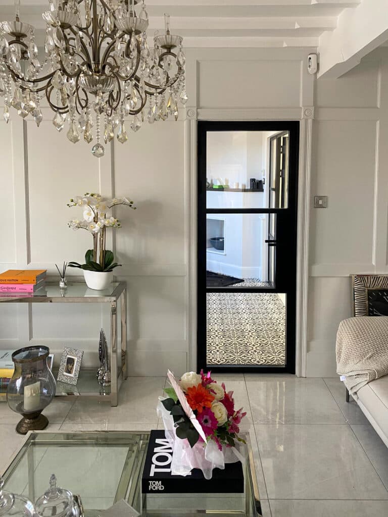 luxury lounge interior with sofa, coffee table and steel-look black door