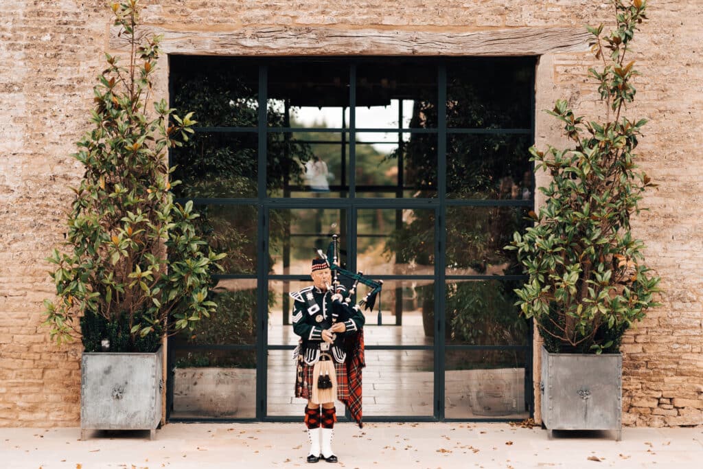 Bagpipe player in front of an industrial style door set